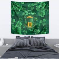 Green clover tapestry wall hanging with “Lucky” text and leprechaun hat icon