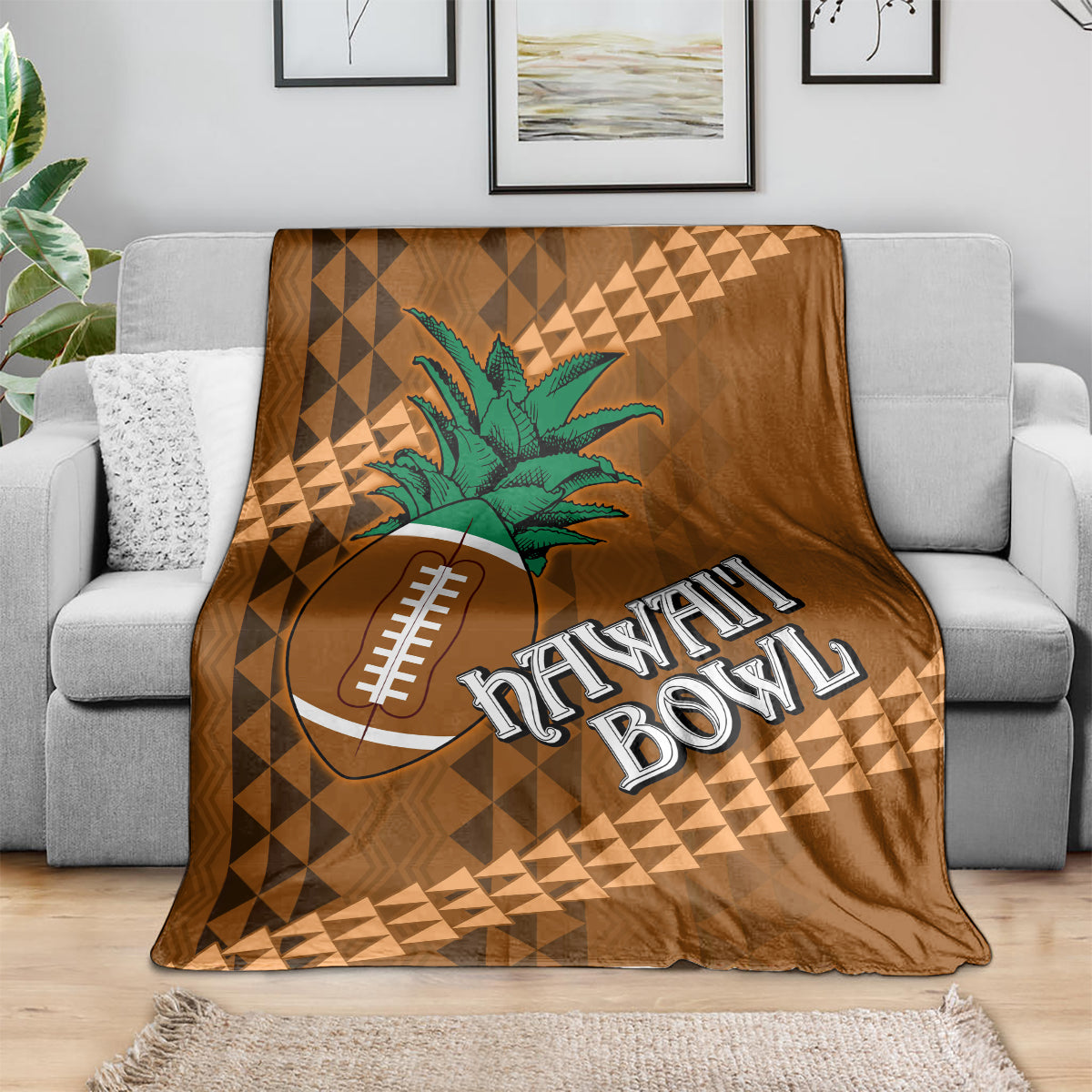 Brown bowl blanket draped on sofa with green palm tree, football icon, and Hawaii Bowl text