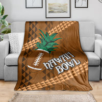 Brown bowl blanket draped on sofa with green palm tree, football icon, and Hawaii Bowl text