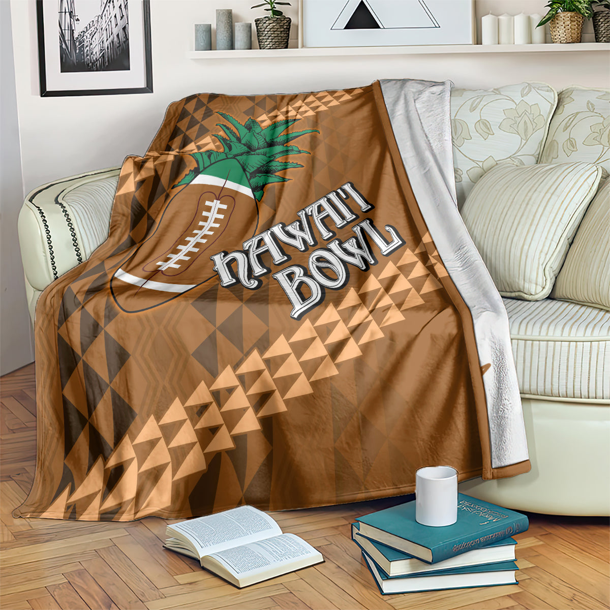 Brown bowl blanket on couch with green palm tree, football icon, and Hawaii Bowl lettering