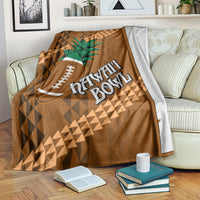 Brown bowl blanket on couch with green palm tree, football icon, and Hawaii Bowl lettering