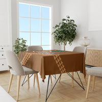 Brown bowl tablecloth with tan geometric stripe pattern across dining table