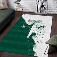 Green and white area rug with white falcon face graphic and Arabic-style calligraphy