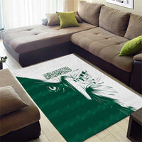 Green and white area rug featuring large white falcon face graphic in center