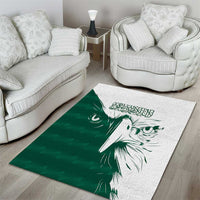 Green and white area rug with white falcon head illustration and Arabic-style writing