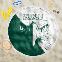 Round green-and-white beach blanket with Saudi falcon print and tassel fringe