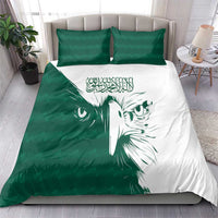 Green and white bedding set with falcon face motif, two green pillows, and duvet on bed