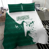 Green and white duvet with falcon face graphic and Arabic calligraphy, plus two green pillows