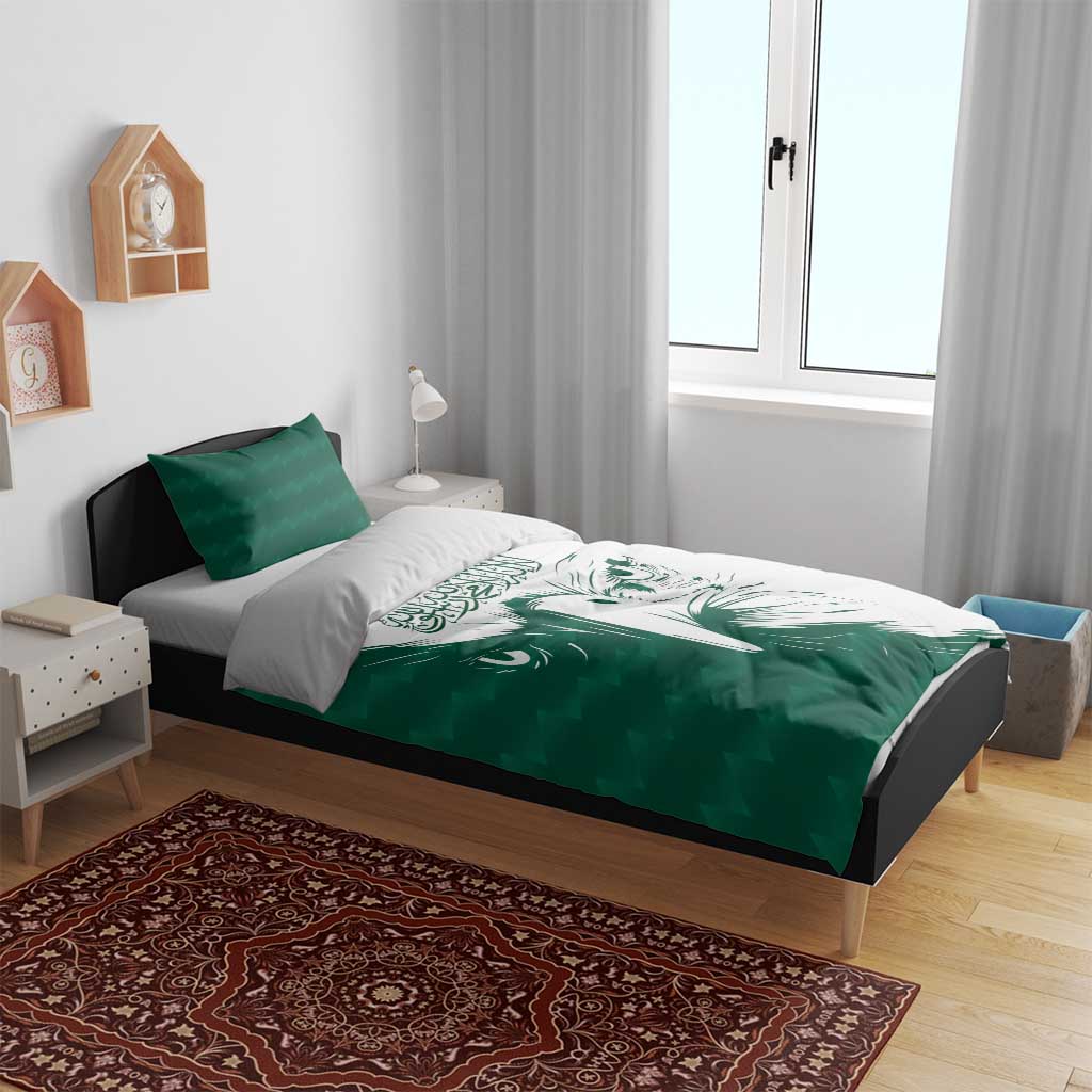Green and white duvet cover set with falcon face design and two green pillows on bed