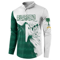 Green and white button henley sweatshirt featuring Saudi falcon face and palm icons