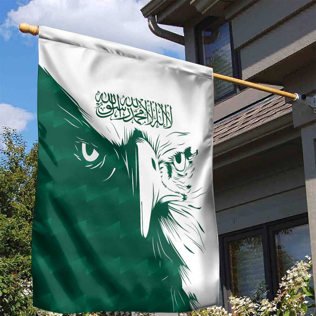 Green and white Saudi falcon garden flag on a gold pole, Arabic script at top