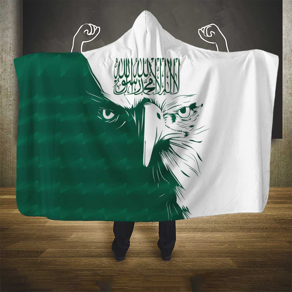 Green and white hooded blanket with falcon face graphic and Arabic calligraphy