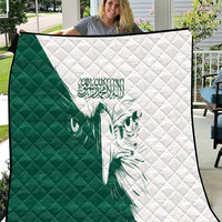 Green and white quilt with diamond stitching and a green falcon graphic panel