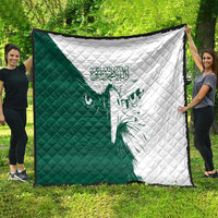 Green and white diamond-stitched quilt with a central falcon illustration