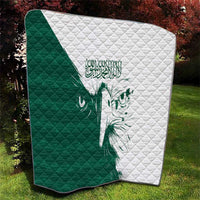 Green and white quilt with diamond quilting and falcon face motif in the center