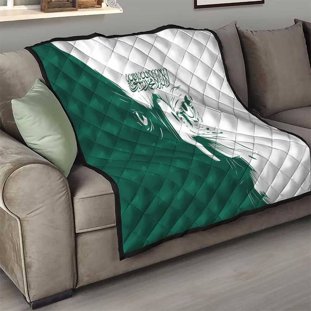 Green and white quilt with diamond stitch pattern and falcon graphic on a sofa