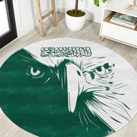 Green round carpet with white falcon graphic and Arabic calligraphy center