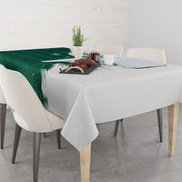 Green and white falcon patterned tablecloth with leaf design, draped on dining table