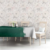 Green and white falcon graphic tablecloth with Arabic-style text, on dining table