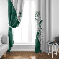 Green and white window curtain panels with falcon design and Arabic script