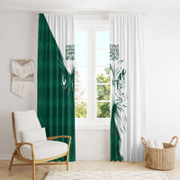 Pleated green and white window curtain panels with falcon head print and Arabic script