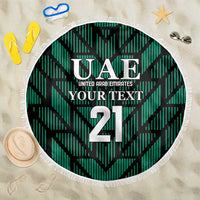 Green round football beach blanket with UAE crest and large 21 graphic, white fringe edge