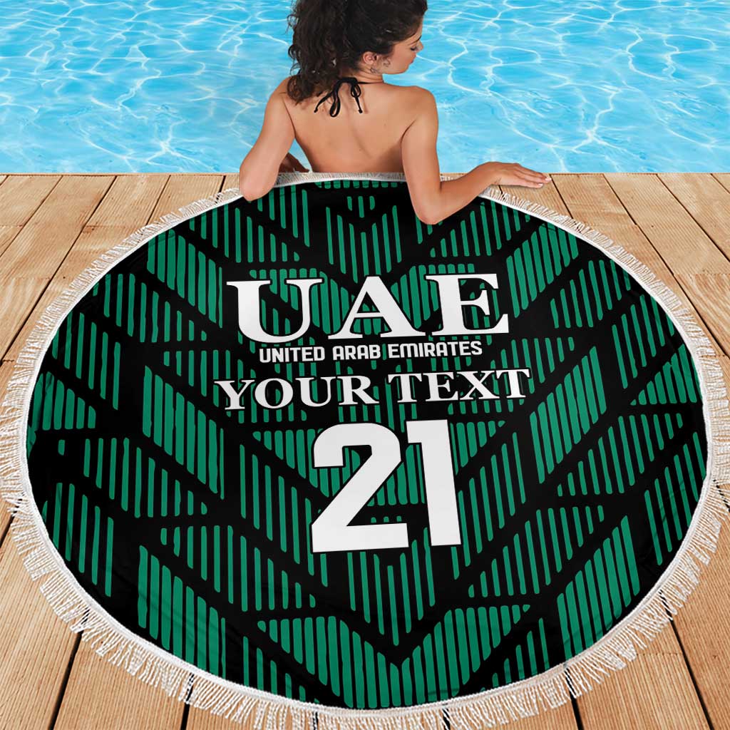 Green circular UAE 21 beach towel blanket with white fringe trim and bold center emblem