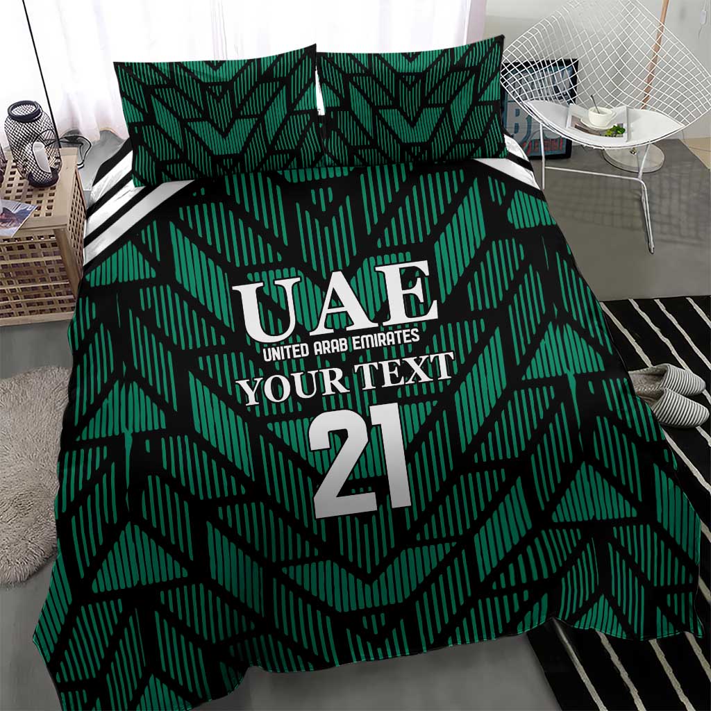 Green comforter with UAE 21 crest and geometric stripe design, with two matching pillows