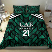 Green UAE football bedding set on bed with UAE 21 crest, geometric stripes, and two pillows