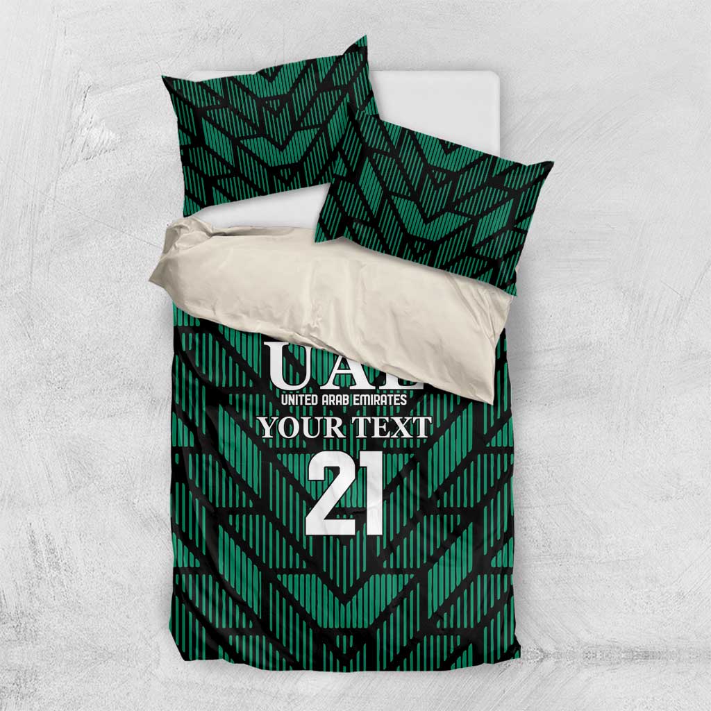 Green UAE bedding set flat lay: comforter with UAE 21 crest and two matching pillowcases