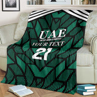 Green football-themed blanket close-up with UAE crest, 'YOUR TEXT', and number 21