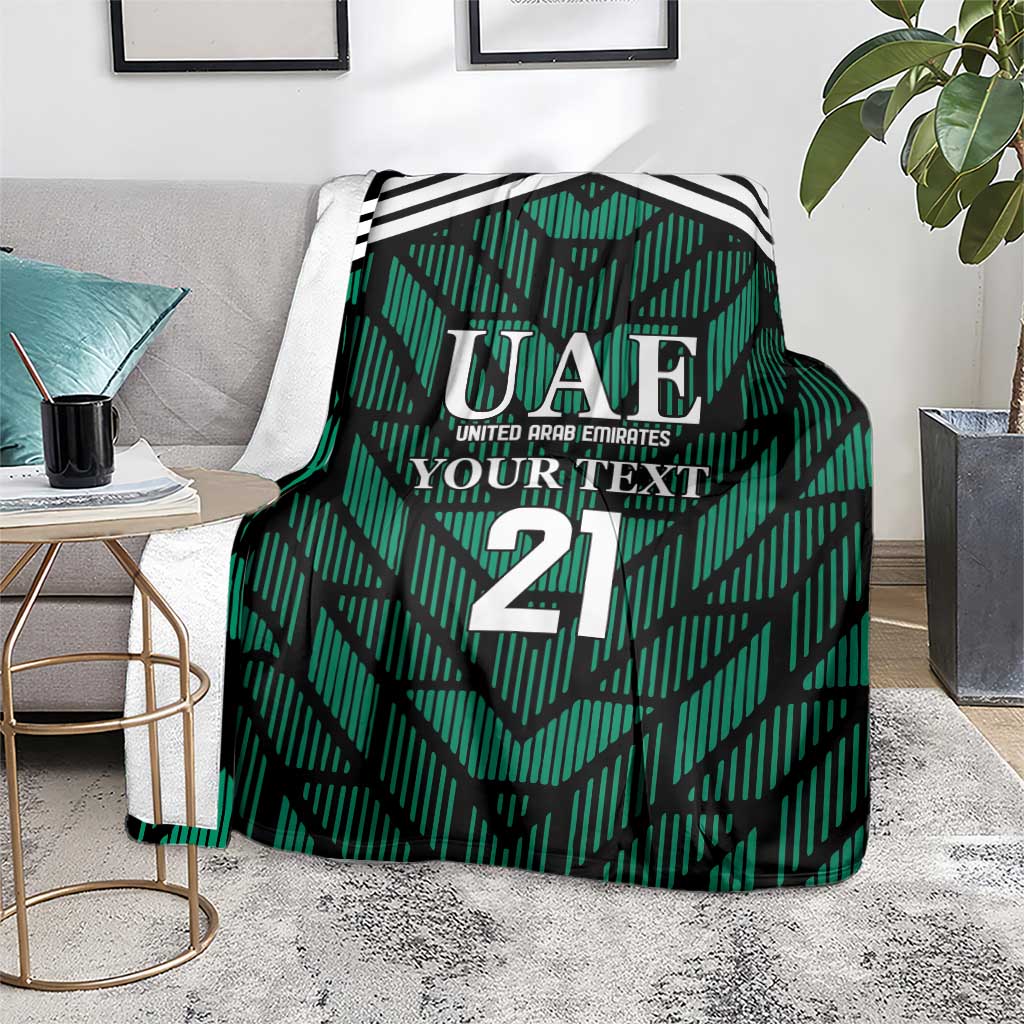 Green football-themed blanket over chair with UAE logo, 'YOUR TEXT', and number 21