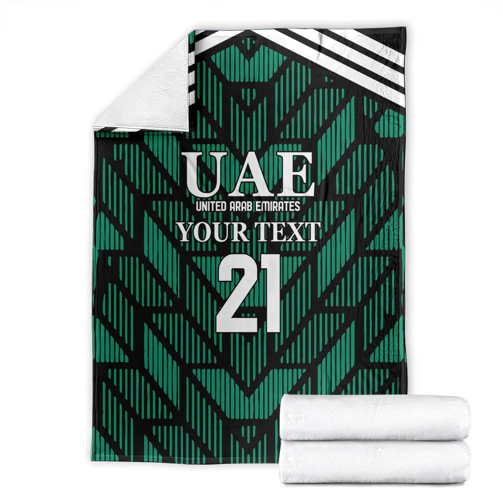 Green football-themed blanket with UAE logo and number 21, shown with folded white towels