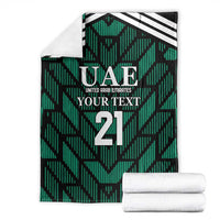 Green football-themed blanket with UAE logo and number 21, shown with folded white towels