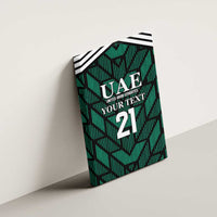 Green UAE football canvas wall art tilted on wall with UAE emblem and large "21"