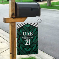 Green UAE garden flag hanging from wooden post, black-and-white stripe top and number 21