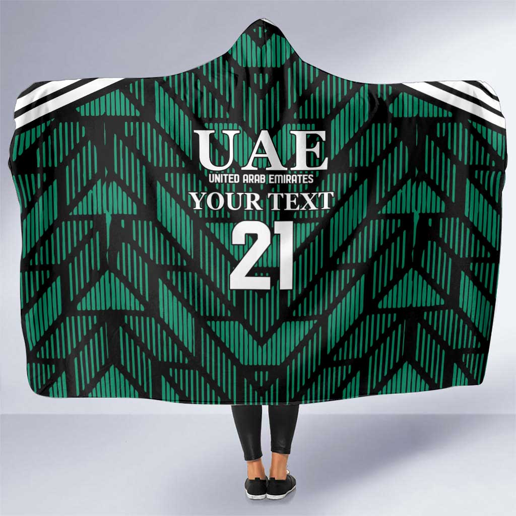 Green hooded football blanket with UAE crest, number 21, and black/white striped trim