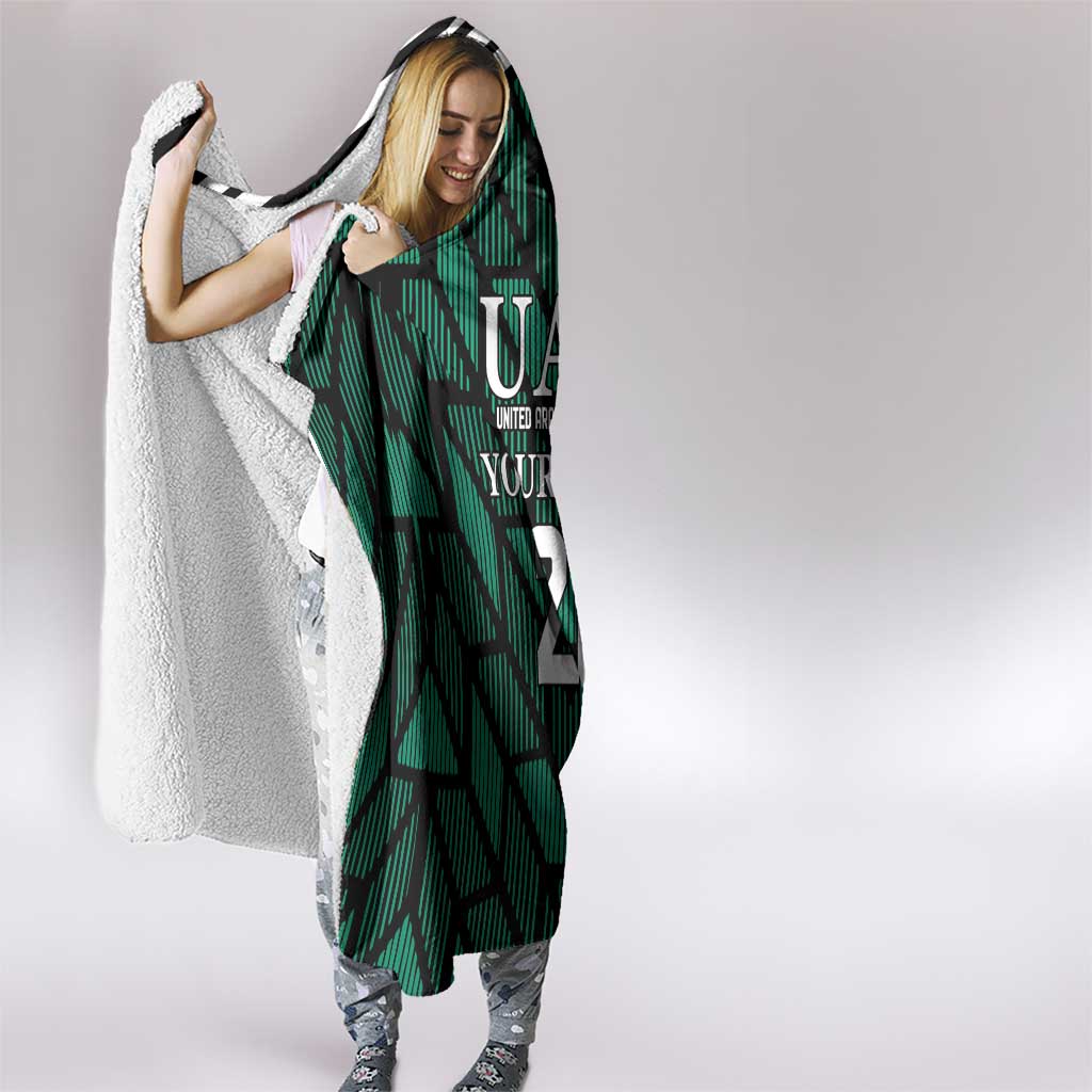 Green hooded football blanket with UAE crest, number 21, striped front and hood