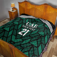 Custom UAE football quilt on bed, green geometric print with white stripes and 21