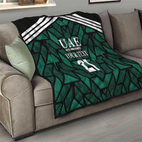 Custom UAE football quilt on couch, green patterned throw with white stripes and 21