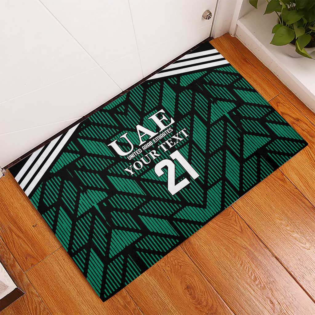 Green UAE football rubber doormat on floorboards, geometric pattern with number 21