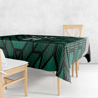 Green football tablecloth with UAE '21' motif draped on dining table