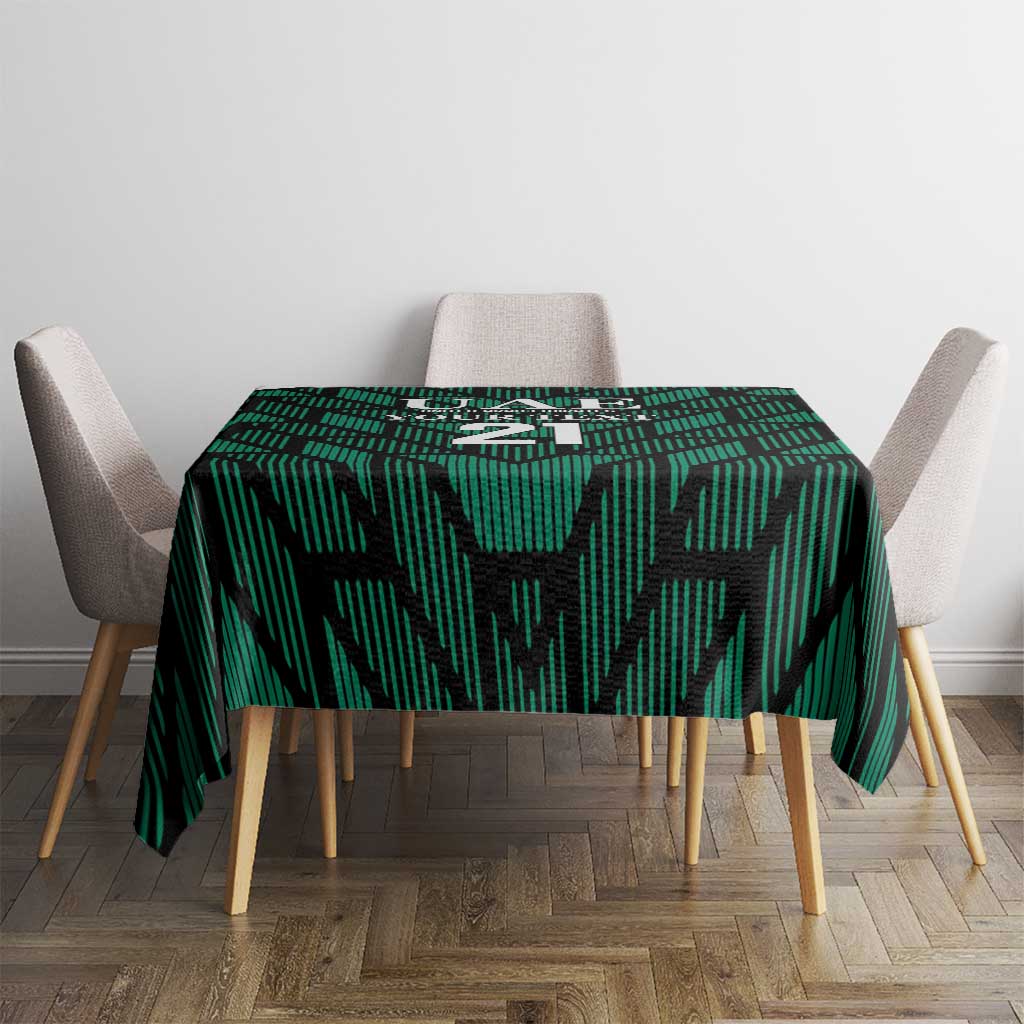 Green football tablecloth with UAE '21' graphic centered on dining table