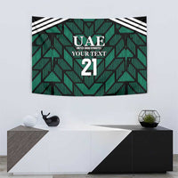 Green wall tapestry showing UAE crest, 'YOUR TEXT' text, and large number 21.