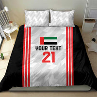 Football bedding set on bed with 2 pillows: black duvet, red striped jersey panel, number 21