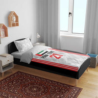 Football bedding set on a wooden bed frame: black duvet with red stripes and number 21, 2 pillows
