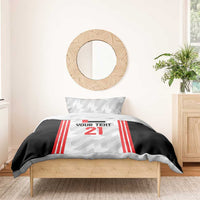 Football bedding set on a small bed: black duvet with red striped jersey panel and number 21, 1 pillow