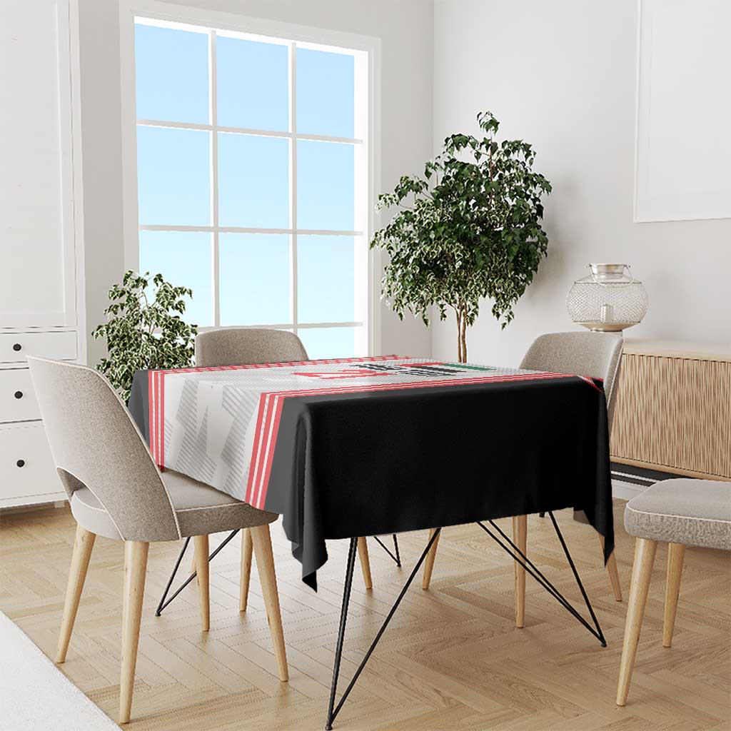 Football tablecloth draped on dining table, black and white base with red stripe borders