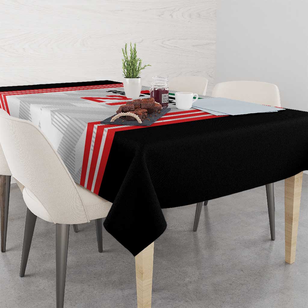 Black football tablecloth with red and white striped design and corners hanging over table