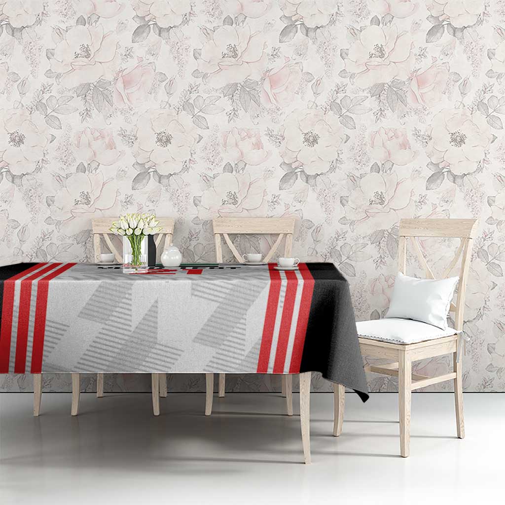 Football tablecloth on rectangular table with black, white, and red striped center panel